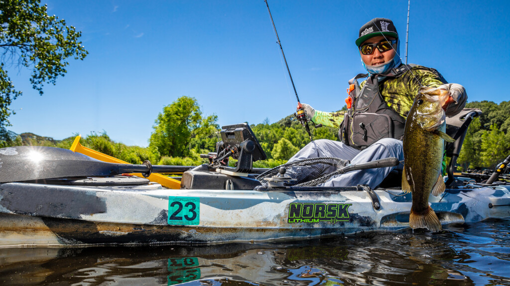 Norsk Lithium kayak angler catching a bass while powering his electronics with a a Norsk Lithium ion battery 1080X1920