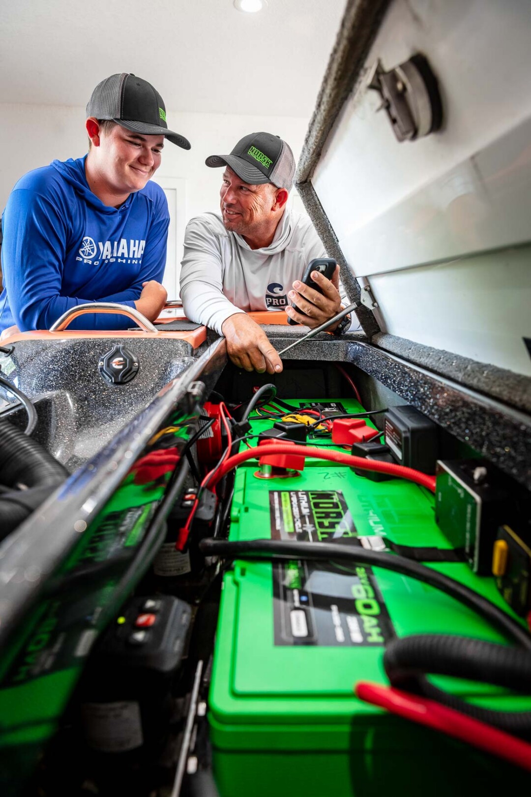 Bobby Lane Checking his two Norsk Lithium 36V 60Ah Batteries using Norsk Guardian Mobile app with his son 010A6903