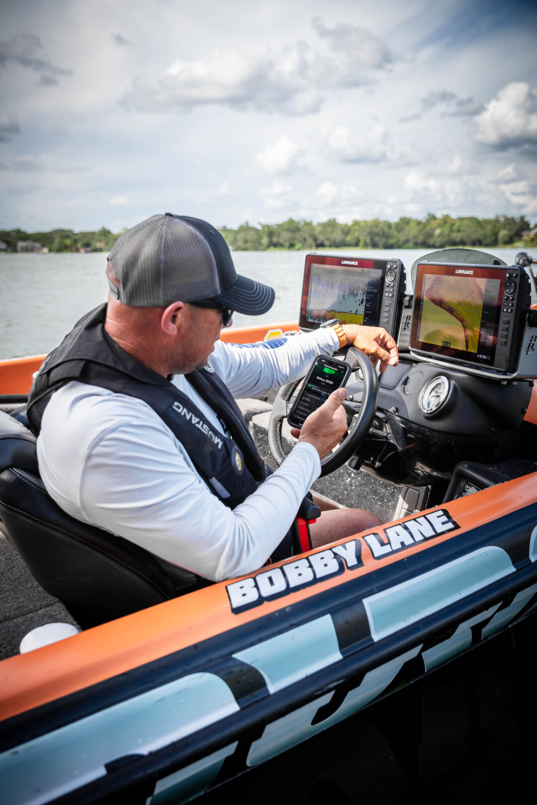 Bobby Lane at the helm checking his two Norsk Lithium 36V 60Ah Batteries using Norsk Guardian Mobile app 010A7238
