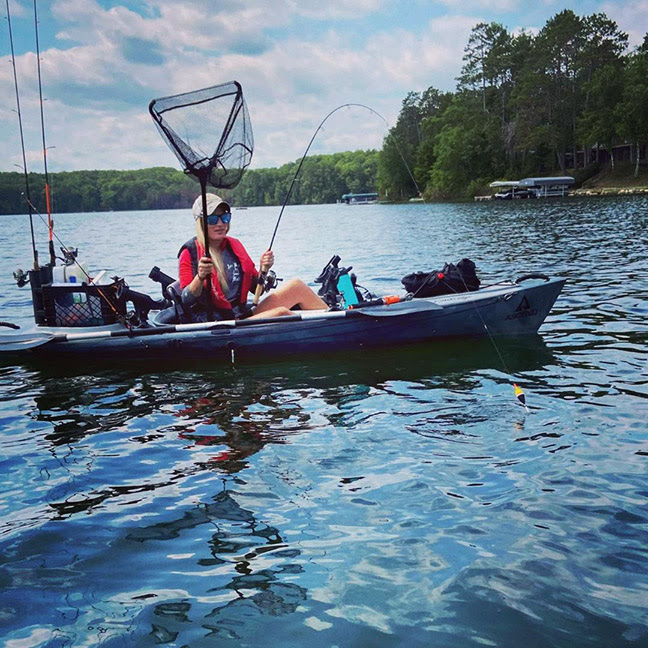 NORSK Lithium Kayak Pro Amy Hansen Preparing to net a fish