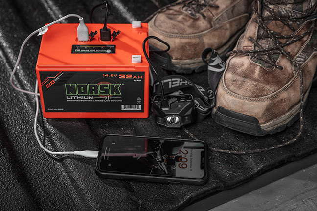 Norsk Lithium 32Ah Battery charging a phone and head lamp on a hunting trip