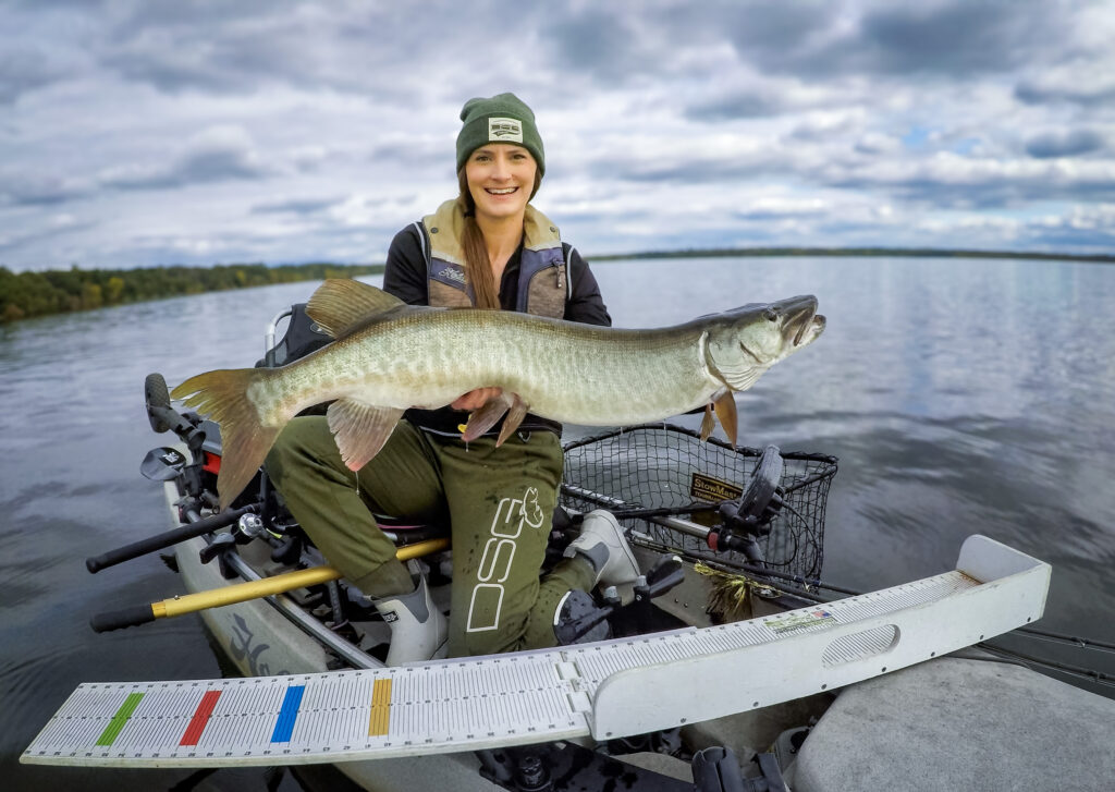 Nicole Lynn Norsk Pro Staff kayak angler holding muskie using Norsk Lithium battery to power electronics 4