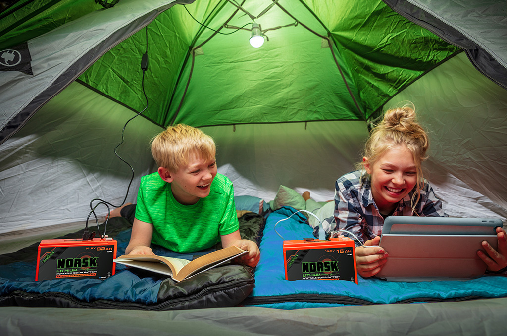 Kids in a Tent using Norsk Lithium Camping Batteres to power up devices