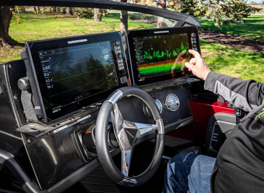 Angler using his Humminbird fishing electronics in his boat powered by Norsk Lithium Batteries